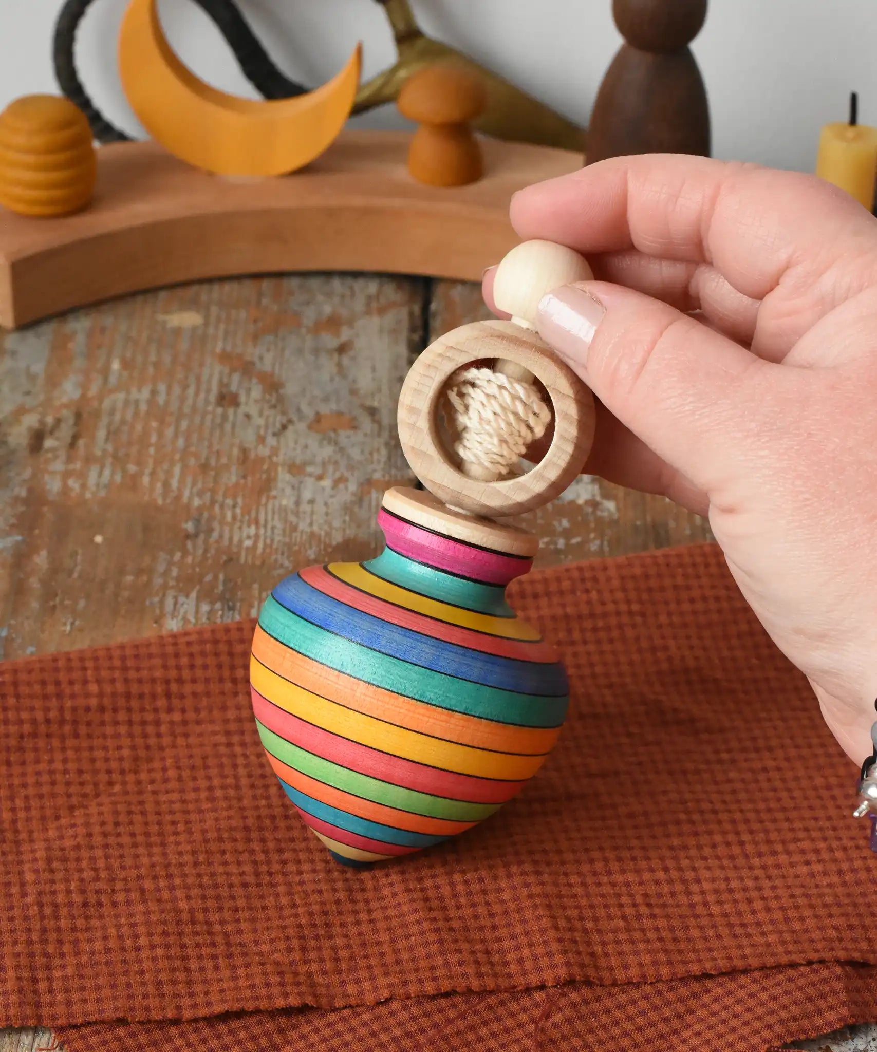 Mader Kreiselmanufaktur ring pull string spinning top placed on a cloth in the Babipur playroom.