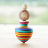Mader Ring Spinning Top spinning in motion on a wooden surface in the Babipur playroom.