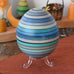 Mader Kreiselmanufaktur roly-poly wooden egg in ice blue placed on the clear display stand in the Babipur playroom.