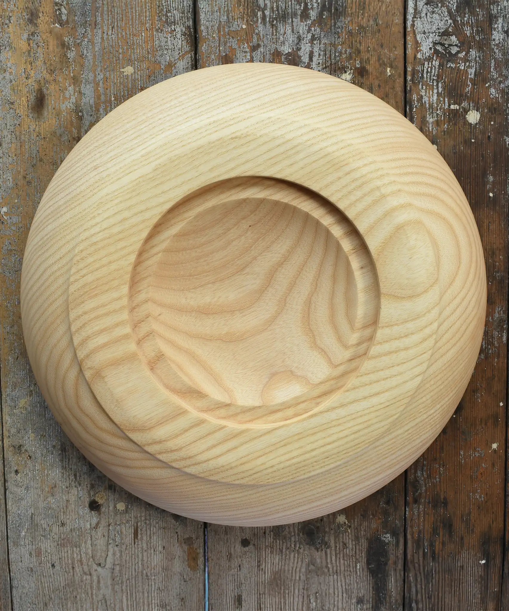 Bottom of the Mader Kreiselmanufaktur Rondell Ash Wood 40cm Spinning Plate placed on a wooden surface in the Babipur playroom.