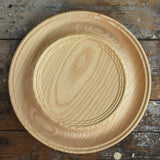 Mader Kreiselmanufaktur Rondell Ash Wood 40cm Spinning Plate placed on a wooden surface in the Babipur playroom.