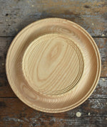 Mader Kreiselmanufaktur Rondell Ash Wood 40cm Spinning Plate placed on a wooden surface in the Babipur playroom.