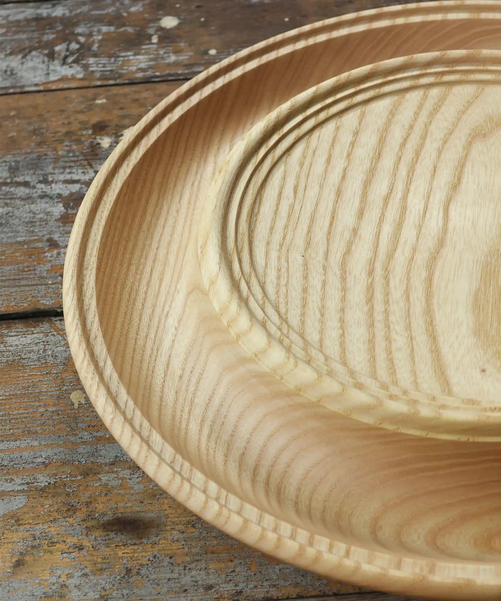 Close up of the Mader Kreiselmanufaktur Rondell Ash Wood 40cm Spinning Plate placed on a wooden surface in the Babipur playroom.