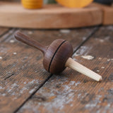Mader Kreiselmanufaktur Salto Totale Walnut / Hornbeam Spinning Top placed on a desk in the Babipur playroom.