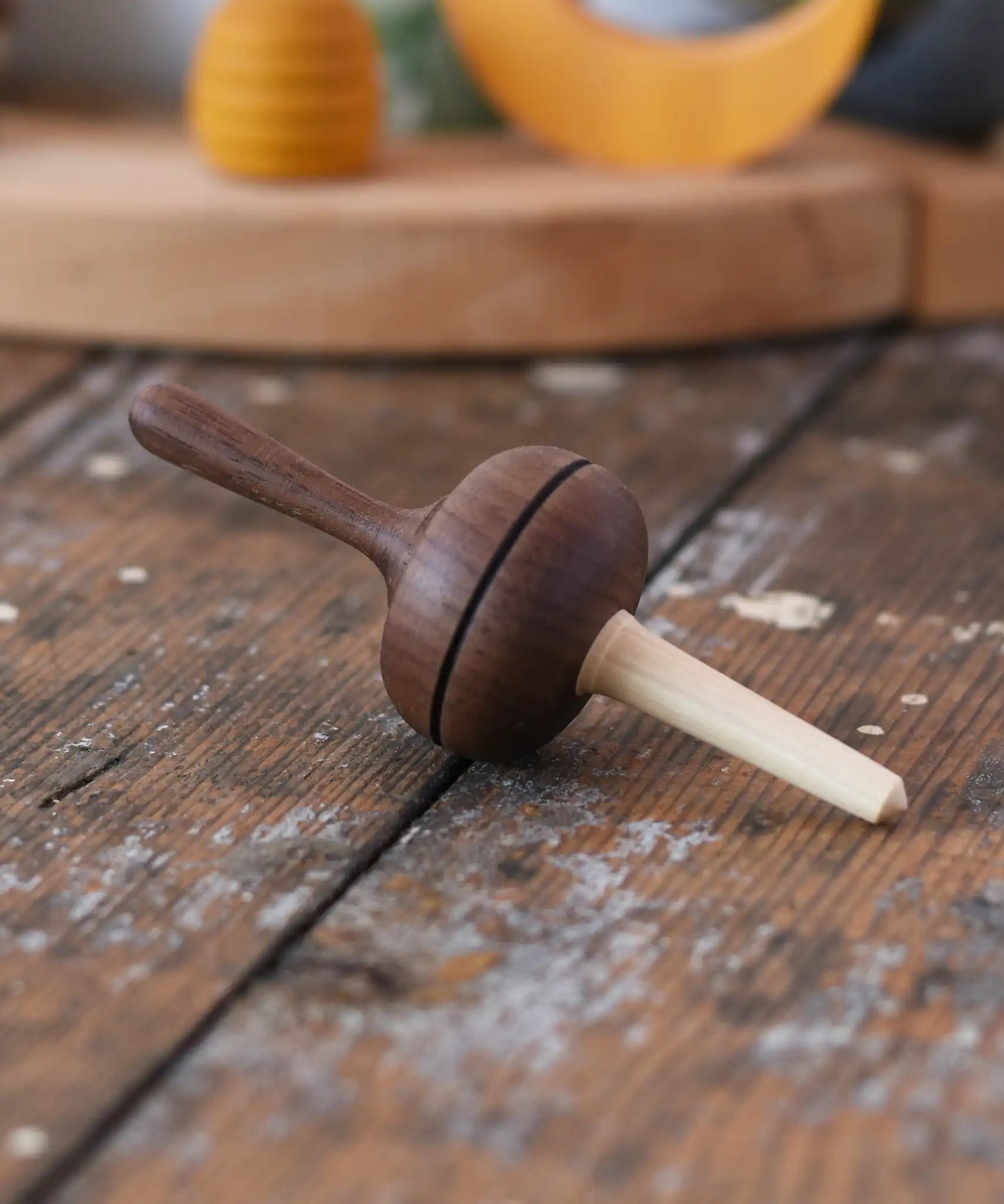 Mader Kreiselmanufaktur Salto Totale Walnut / Hornbeam Spinning Top placed on a desk in the Babipur playroom.