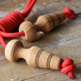Mader Kreiselmanufaktur Children's Skipping Rope with Natural Handles placed on a wooden surface in the Babipur playroom. 