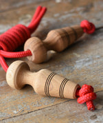 Mader Kreiselmanufaktur Children's Skipping Rope with Natural Handles placed on a wooden surface in the Babipur playroom. 