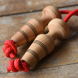 Mader Kreiselmanufaktur Children's Skipping Rope with Natural Handles placed on a wooden surface in the Babipur playroom. 