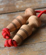 Mader Kreiselmanufaktur Children's Skipping Rope with Natural Handles placed on a wooden surface in the Babipur playroom. 