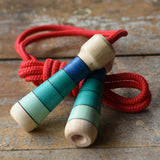 Mader Skipping Rope with Blue Handles placed on a wooden board in the Babipur playroom.