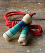 Mader Skipping Rope with Blue Handles placed on a wooden board in the Babipur playroom.