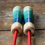 Close up of top of the handles on the Mader Skipping Rope with Blue Handles placed on a wooden board in the Babipur playroom.