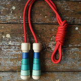 Mader Skipping Rope with Blue Handles placed on a wooden board in the Babipur playroom.