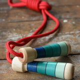 Mader Skipping Rope with Blue Handles placed on a wooden board in the Babipur playroom.