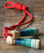 Mader Skipping Rope with Blue Handles placed on a wooden board in the Babipur playroom.