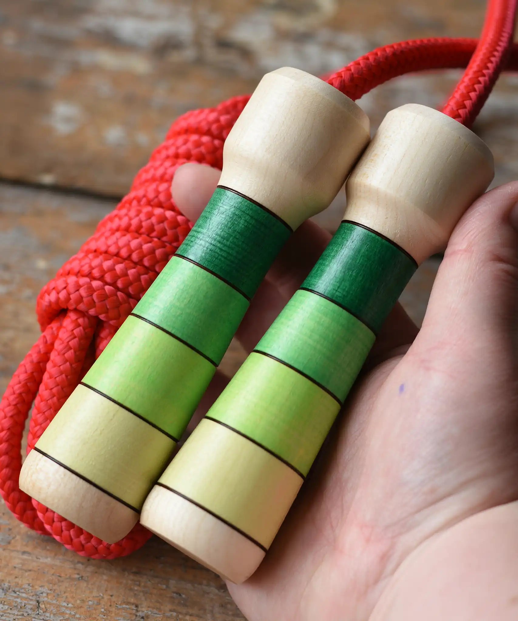 Mader Skipping Rope with Green Handles in an adult hand. 