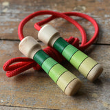 Mader Skipping Rope with Green Handles placed on a wooden board in the Babipur playroom. 