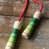 Mader Skipping Rope with Green Handles placed on a wooden board in the Babipur playroom. 