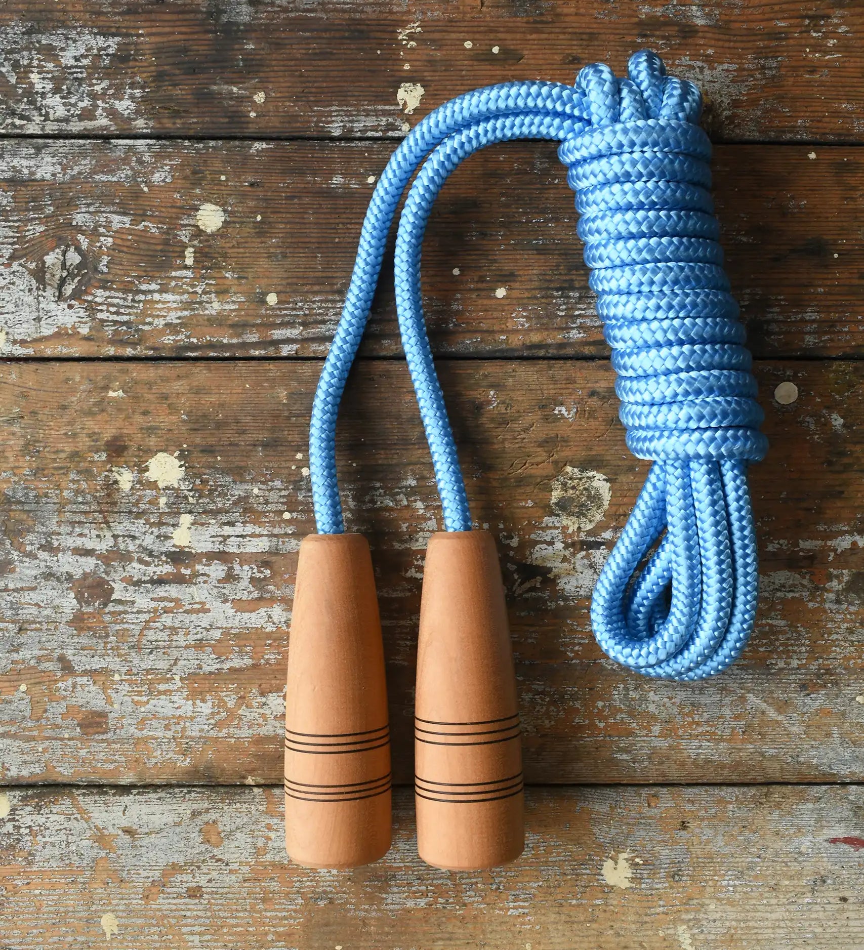 Mader Kreiselmanufaktur Children's Skipping Rope Natural Handles 5m length placed on a wooden surface in the Babipur playroom. 