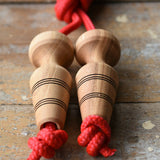Mader Kreiselmanufaktur Children's Skipping Rope with Natural Handles placed on a wooden surface in the Babipur playroom. 