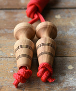 Mader Kreiselmanufaktur Children's Skipping Rope with Natural Handles placed on a wooden surface in the Babipur playroom. 