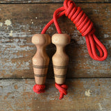 Mader Kreiselmanufaktur Children's Skipping Rope with Natural Handles placed on a wooden surface in the Babipur playroom. 