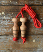 Mader Kreiselmanufaktur Children's Skipping Rope with Natural Handles placed on a wooden surface in the Babipur playroom. 