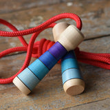 Mader Kreiselmanufaktur Children's Skipping Rope with Purple Handles placed on a wooden surface in the Babipur playroom. 