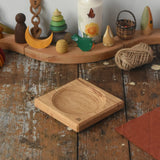 Mader Small Oak Spinning Plate placed on a wooden surface in the Babipur playroom.