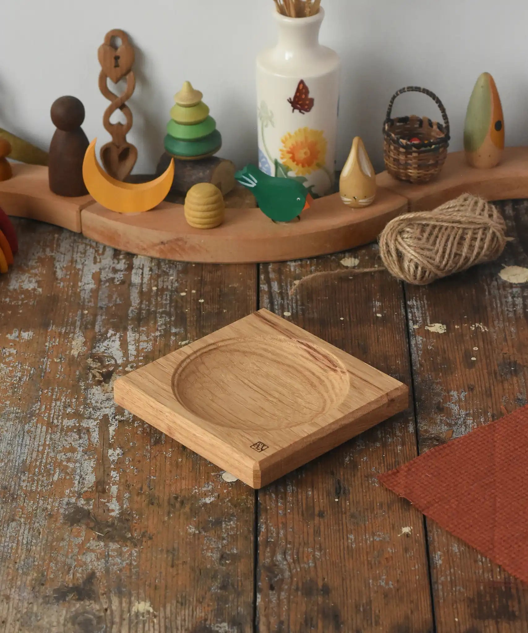 Mader Small Oak Spinning Plate placed on a wooden surface in the Babipur playroom.