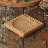 Mader Small Oak Spinning Plate placed on a wooden surface in the Babipur playroom.