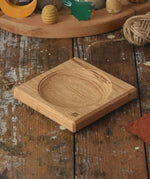 Mader Small Oak Spinning Plate placed on a wooden surface in the Babipur playroom.
