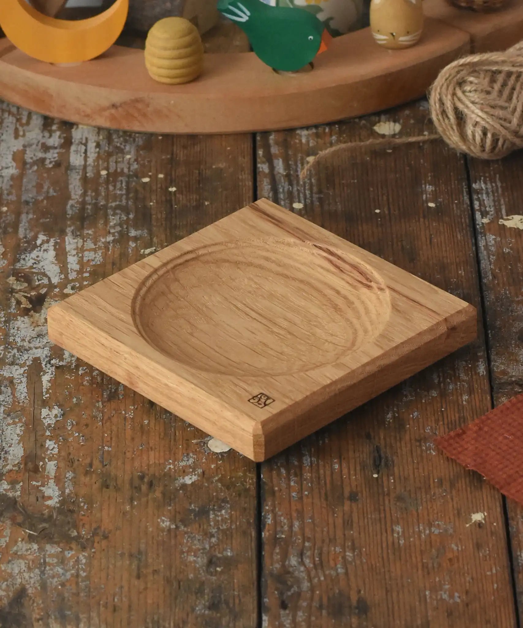 Mader Small Oak Spinning Plate placed on a wooden surface in the Babipur playroom.