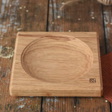 Mader Small Oak Spinning Plate placed on a wooden surface in the Babipur playroom.