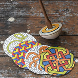 Mader 'So And So' DIY Spinning Top Set placed on a wooden desk in the Babipur playroom.