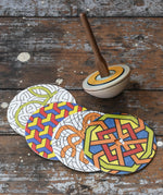 Mader 'So And So' DIY Spinning Top Set placed on a wooden desk in the Babipur playroom.