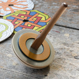 Mader 'So And So' DIY Spinning Top Set placed on a wooden desk in the Babipur playroom.