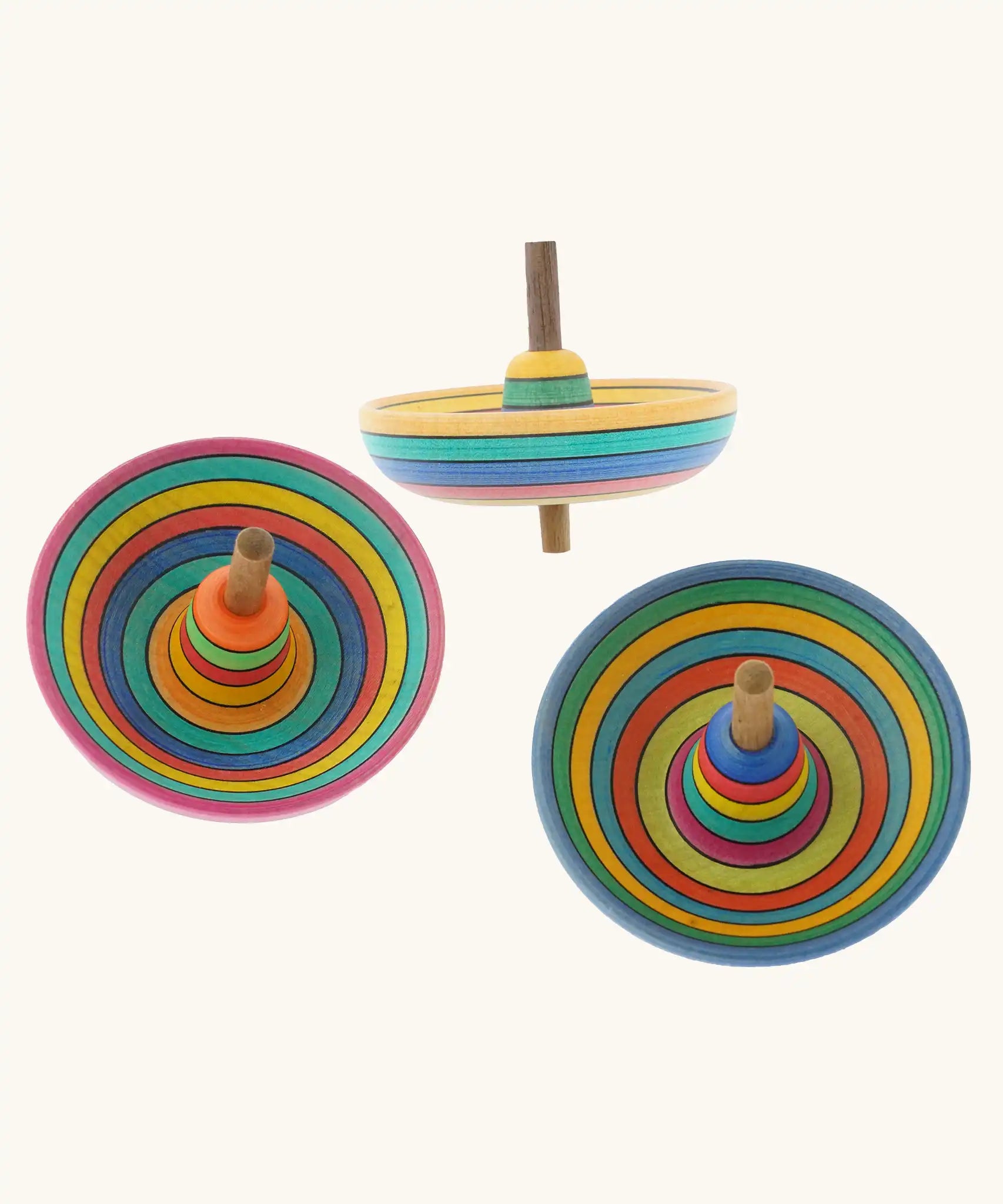 Three Mader Kreiselmanufaktur Sombrero Spinning Tops with a rainbow coloured striped design.