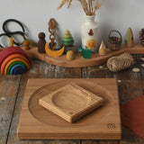 Mader Small Oak Spinning Plate placed on large 25cm spinning plate  in the Babipur playroom. Grimm's celebration ring set up in the background.