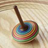 Mader stripe spinning top placed on a spinning plate. 
