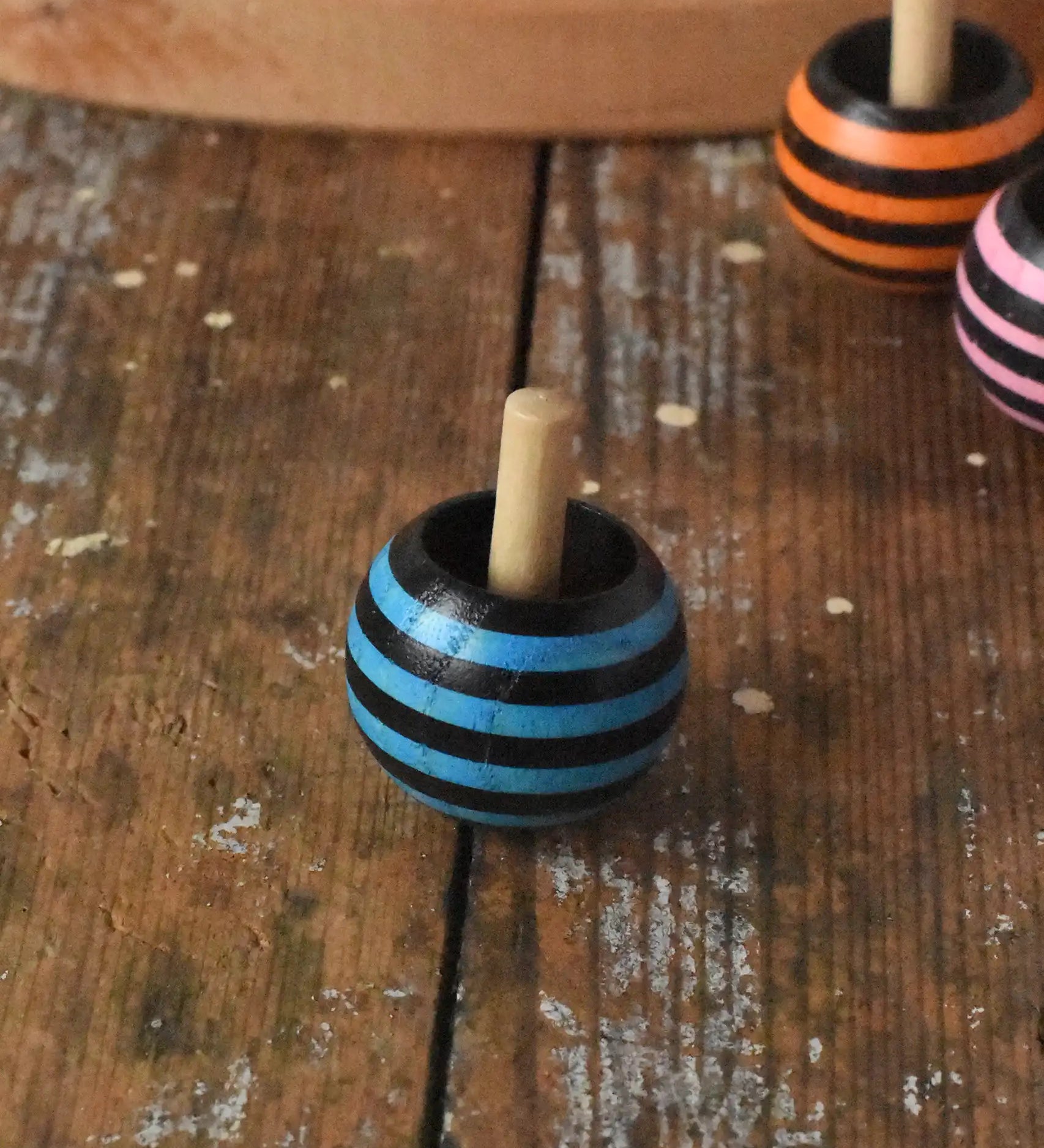 Mader tango turn-over spinning top placed on a wooden desk in the Babipur playroom. 