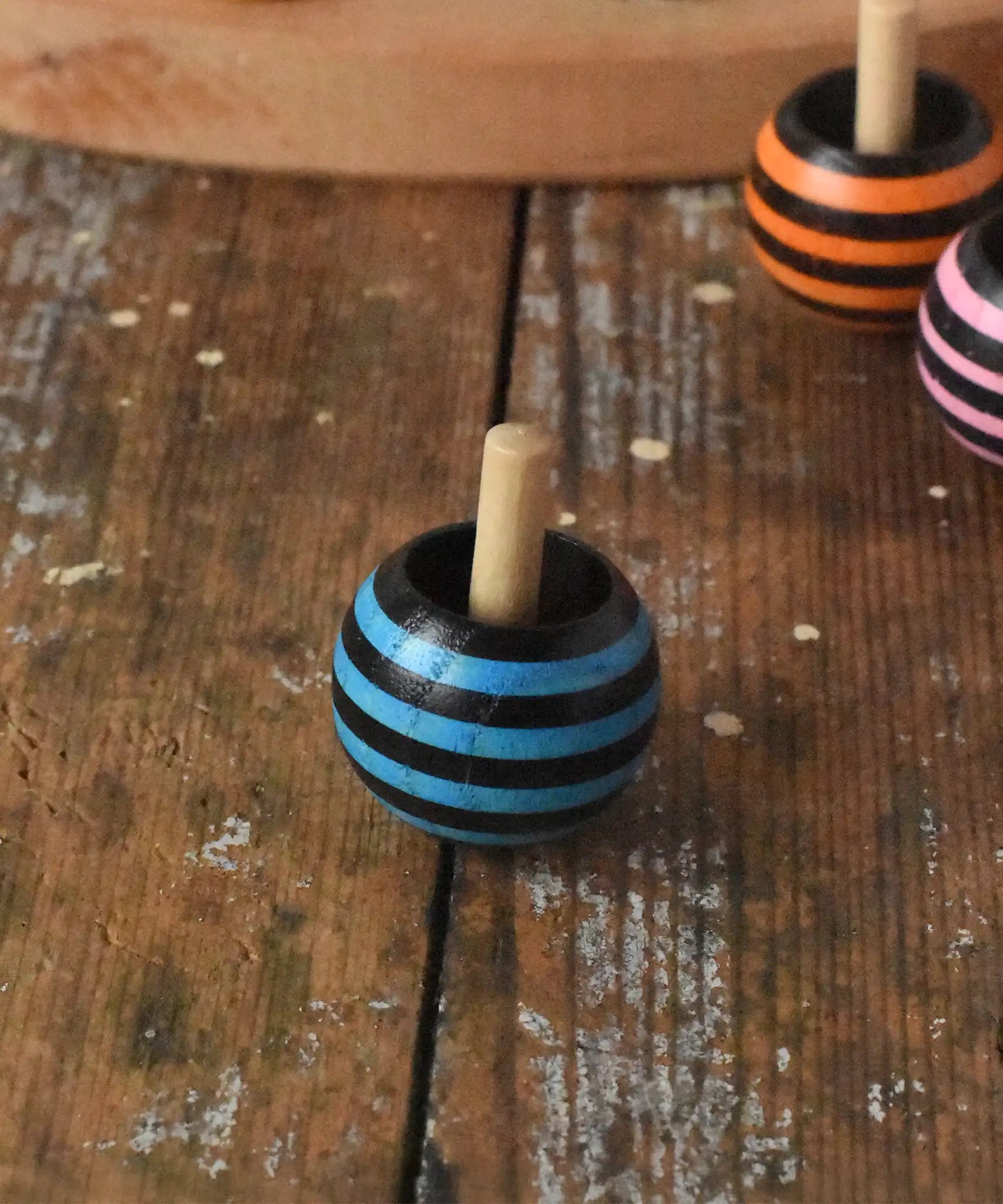 Mader tango turn-over spinning top placed on a wooden desk in the Babipur playroom. 