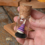 Mader Tarantella On Stage mini spinning top in an adult hand in the Babipur playroom. 