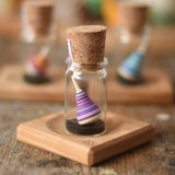 Mader Tarantella On Stage mini spinning top and plate set placed on a desk in the Babipur playroom. 