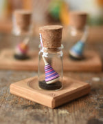 Mader Tarantella On Stage mini spinning top and plate set placed on a desk in the Babipur playroom. 