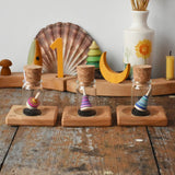 Three Mader Tarantella On Stage mini spinning top and plate set placed on a desk in the Babipur playroom. 