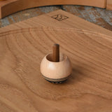 Mader orient turn-over spinning top placed on an oak spinning plate on a  wooden desk in the Babipur playroom.