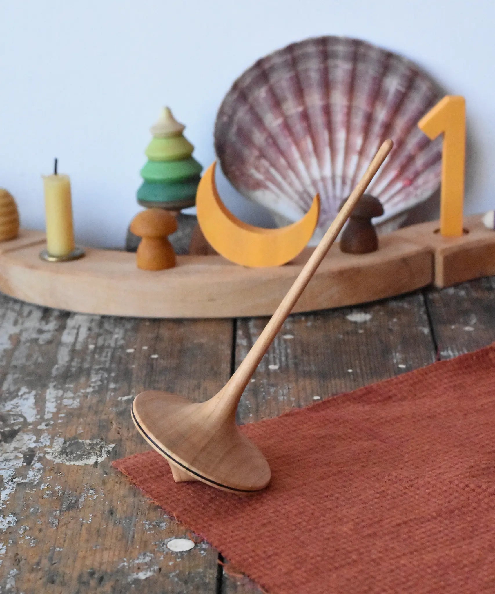 Mader trumpo spinning top 55mm placed on a wooden surface in the Babipur playroom.