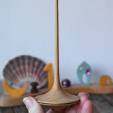 Mader trumpo spinning top 55mm in an adult's hand.