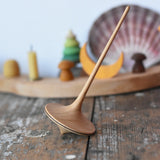 Mader trumpo spinning tops 55mm placed on a wooden surface in the Babipur playroom.